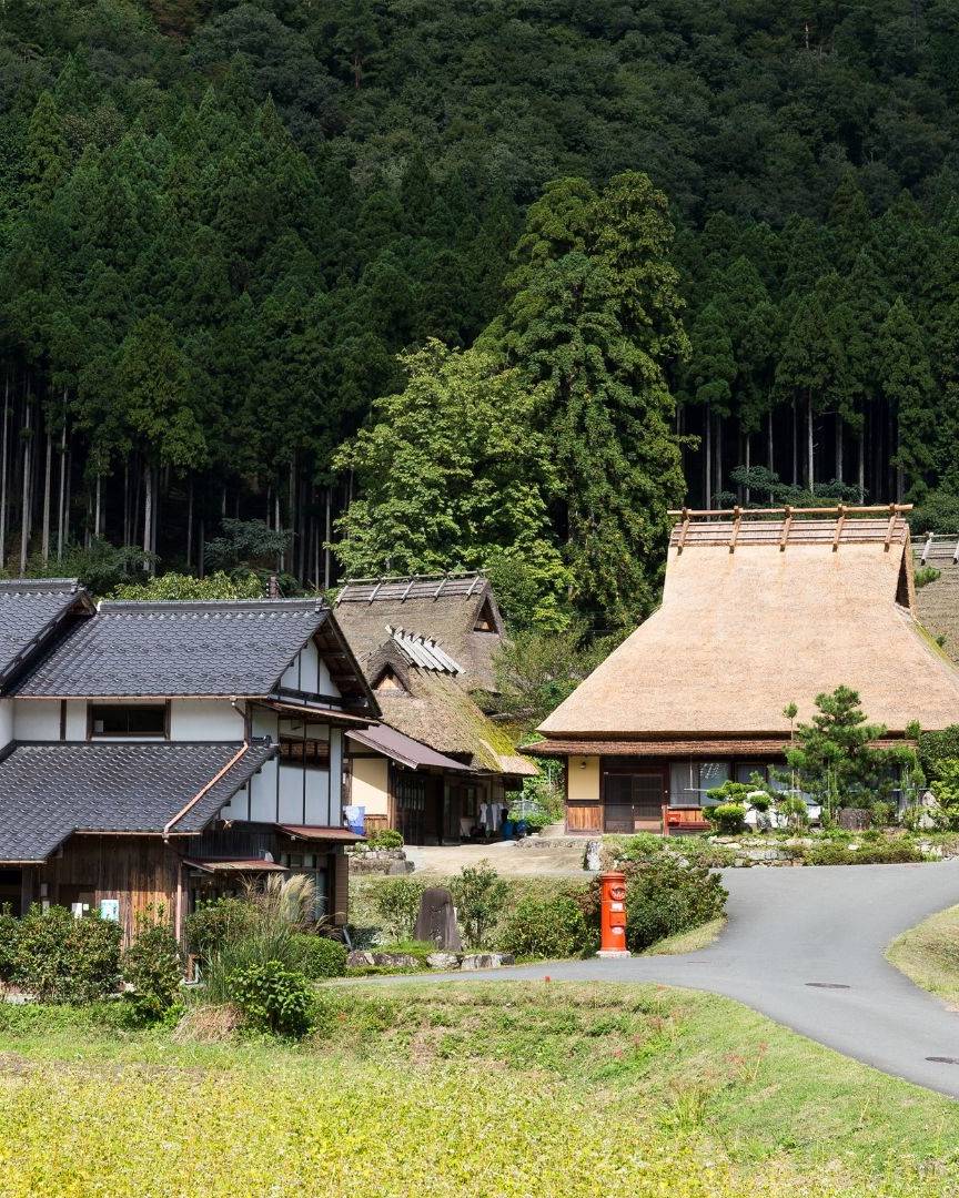 Traditional Japanese village with thatched roof houses.